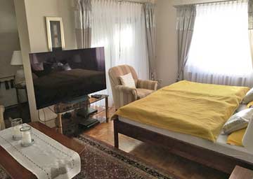 Schlafzimmer mit TV und Sofaecke