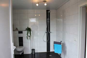 Badezimmer mit Dusche und WC bei der Sauna